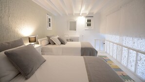 A bedroom with two beds, a nightstand, a lamp, and a window with a view. - Villa Fragkia/private lounge area, sea view (Kalafatis)