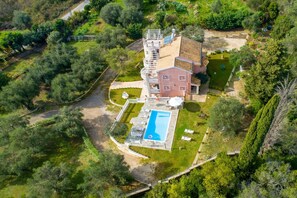 An aerial view of a large, multi-story house with a swimming pool, surrounded by lush greenery and a well-maintained garden. - Eleonas in Kato Korakiana (Corfu)