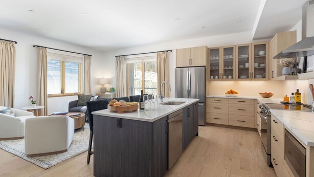 A modern kitchen with a central island, built-in appliances, and light wood cabinetry. - 5BR Ski-In Condo in Okemo Mountain | Near Lifts! (Ludlow)