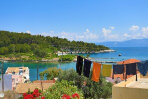 A coastal view with a clear sky, a body of water, and buildings with terracotta roofs. - Faros Exi in Gaios with 1 bedrooms and 1 bathrooms (Gaios)