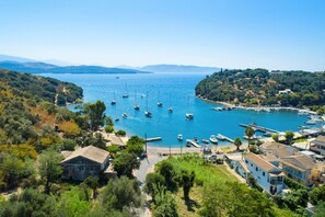 A coastal town with boats docked along the harbor, surrounded by greenery and buildings. - The Old Office in Kalami (Kalami)