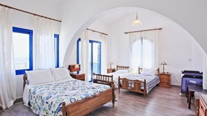 A bedroom with two wooden beds, a desk, and a chair. - Villa Mandola Rosa in Poli Crysochous (Poli Crysochous)
