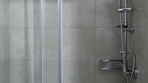 A modern shower with a handheld showerhead, a wall-mounted faucet, and a handheld showerhead. - Stagiates Guest House Room 3 (Μακρινίτσα)
