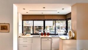 A modern kitchen with a window, sink, and cabinets. - Rupin Nacre in Tel Aviv-Yafo (Tel Aviv-Yafo)