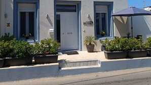 A building with a white facade, three windows, a door, and a sign that reads 'CASA D'ORO LIVING.' - Casa d'oro 56 Living in Paradisi Rhodes (Paradisi)