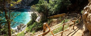 A coastal path with a wooden fence, rocky terrain, and a clear blue sea. - Villa Zina  Studio 2 (Agios Dimitrios Piliou)