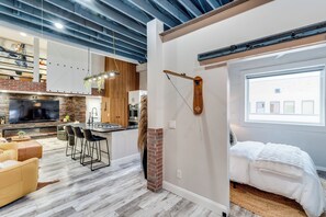 A modern interior with a kitchen, dining area, and a bedroom. - Loft N' Loaded: Downtown Wichita Luxury Loft (Wichita)