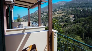 A balcony with a view of a mountainous landscape.