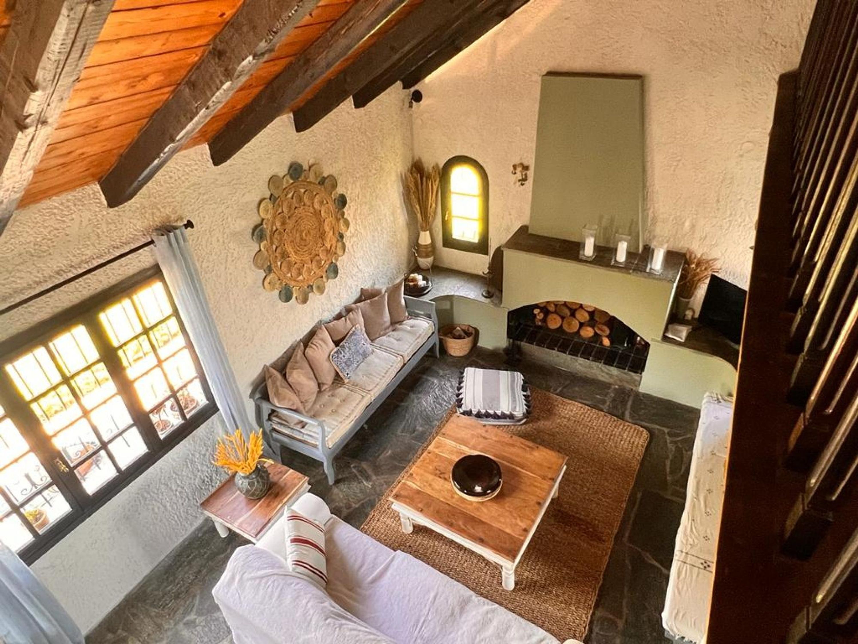 A cozy living room with a sofa, coffee table, and fireplace.