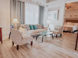 A living room with a sofa, two armchairs, a coffee table, and a TV. - Beautiful home near Englewood Beach (Rotonda West)