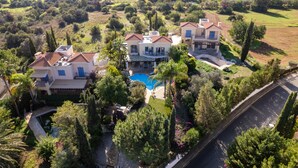A large estate with multiple houses, a swimming pool, and lush greenery. - Latchi Aria Villa in Latchi (Latchi)