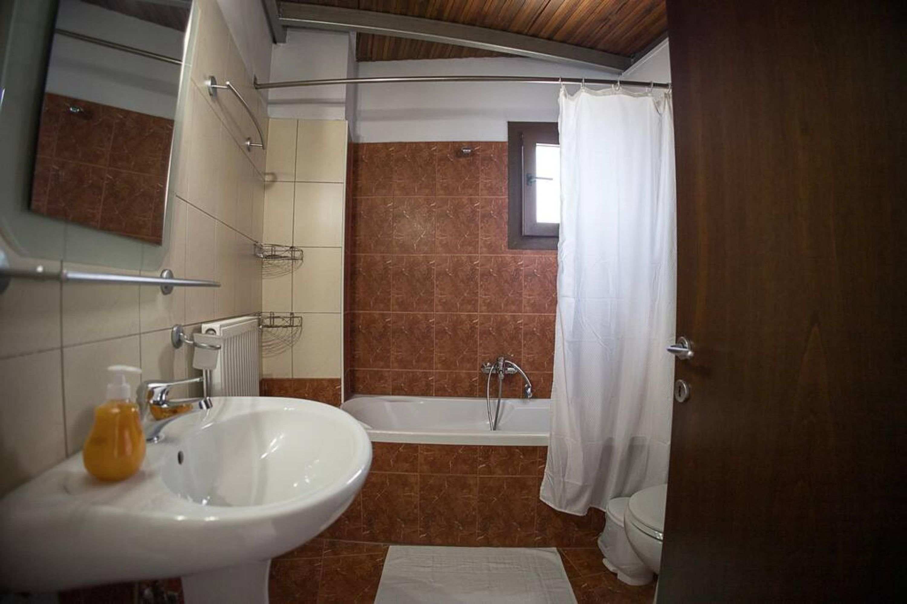 A bathroom with a sink, bathtub, and toilet.