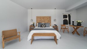 A modern bedroom with a large bed, wooden furniture, and a small table with flowers. - Duchess Suite - Cavalier Suites (Nikiana)