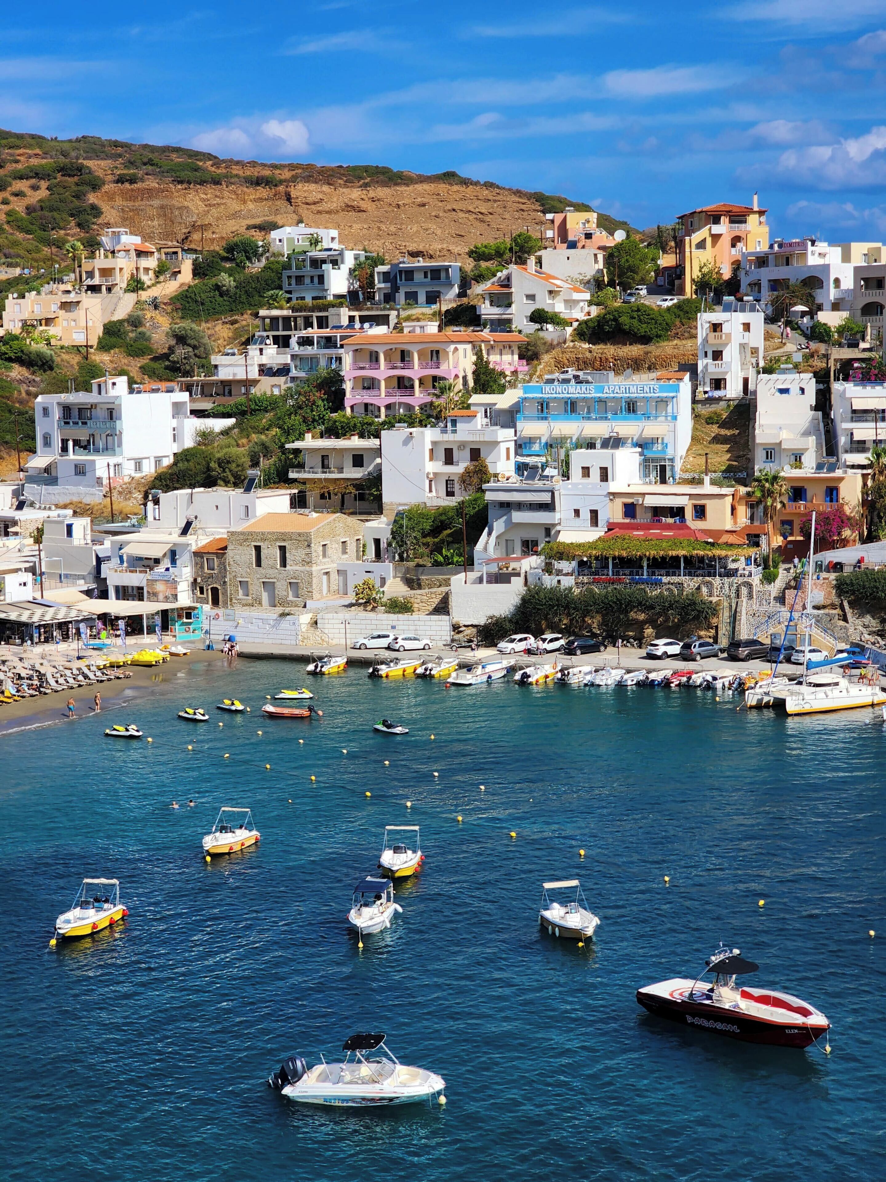 A coastal town with buildings, a marina, and boats.