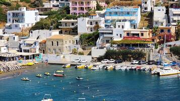 A coastal town with buildings, a marina, and boats.