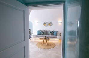 Un salon moderne avec un canapé, une table basse et des œuvres d’art décoratives au mur.