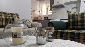 A cozy living room with a sofa and a table with decorative jars.