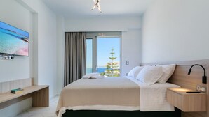 A modern bedroom with a bed, bedside table, and a TV mounted on the wall. - Villa Erato – Agios  Onoufrios (Kounoupidiana)