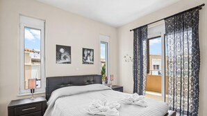 A bedroom with a bed, bedside tables, and curtains. - Villa Blue Dreams in Maleme (Maleme)