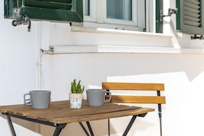 A wooden table with two gray mugs and a potted plant. - Lala's - Superior Double Studio (Naxos)