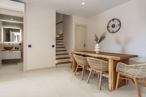 A modern kitchen with a wooden countertop, white cabinets, and a built-in oven. - Cameo 3  Luxury Villa with Pool (Zakynthos)