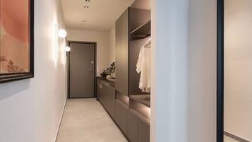 A hallway with a modern design, featuring a long, narrow space with a neutral color palette.