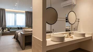 A modern bathroom with two sinks, a large mirror, and a window with curtains.