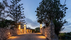 A stone pathway leading to a building with a stone wall on one side and trees on the other. - La Belle Villa - Family Retreat & Magnificent View (Zakinthos)