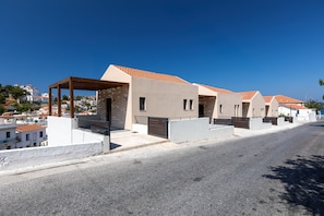 A row of modern, single-story buildings with a uniform architectural style, featuring flat roofs and a minimalist design.