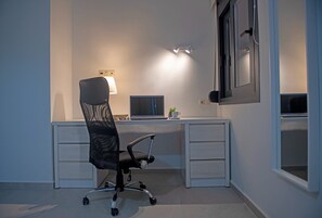 A modern office space with a desk, chair, and computer.