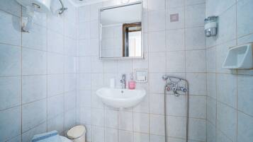 Ein Badezimmer mit Waschbecken, Toilette und Dusche.