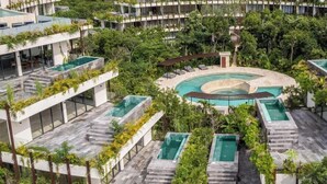 A modern hotel with multiple swimming pools surrounded by lush greenery and terraces. - Private pool, jungle view, AC and fast WI-Fi (Tulum)
