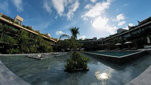 A modern hotel with a central pool, surrounded by lush greenery and multiple swimming pools. - Beautiful two bedroom for 6 guests (Tulum)