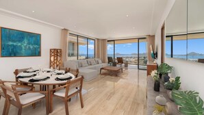 A spacious living area with a dining set, a sofa, and a view of the sea. - Enjoy your perfect vacation in this 3 bd (Cabo San Lucas)
