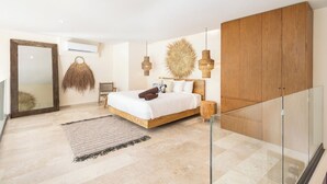 A modern bedroom with a large bed, a glass railing, a woven wall hanging, and a wooden wardrobe. - One of a kind! Loft with small pool (Tulum)
