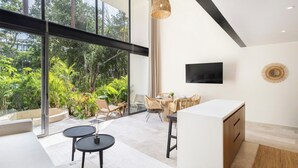A modern kitchen with a large window overlooking a lush garden. - One of a kind! Loft with small pool (Tulum)