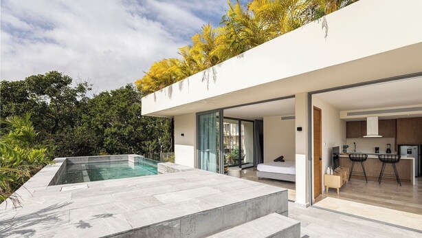 Une maison moderne avec une piscine, une cuisine et une chambre.