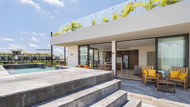 A modern outdoor living area with a pool, steps leading to a covered patio, and a view of the adjacent building. - Unique unit, private pool, terrace, views! (Tulum)