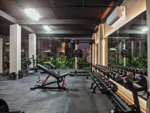 A gym with various exercise equipment, including dumbbells and weight machines. - Tulum retreat at Mistiq Gardens (Tulum)