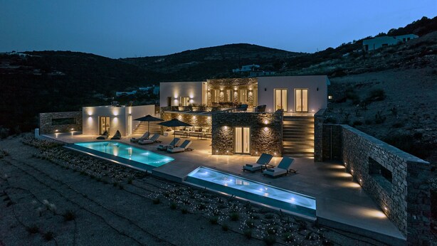 A modern two-story house with a swimming pool, outdoor seating, and stone walls. - Aegean Hestia Luxury Villa of Paros (Paros)