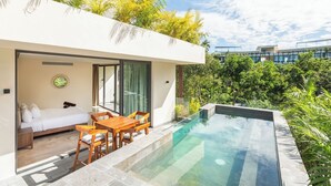 A modern outdoor pool area with a glass-enclosed bedroom and a wooden dining set. - Fast Wi-Fi, private pool, A/C and jungle view! (Tulum)