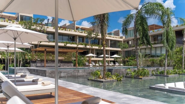 A modern resort with a pool area, lounge chairs, and a bar. - Perfect for family trips! 2 bedroom 3 beds AP (Tulum)