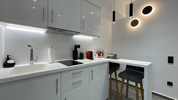 Coffee/tea maker, fridge, stovetop, spices
