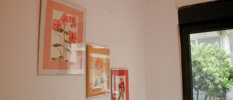 A wall with three framed floral artworks.
