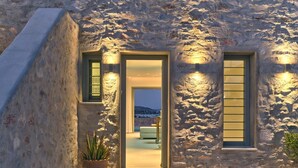 A stone building with a doorway leading to a room with a view of the landscape. - Villa Helia with swimming pool (Naousa)