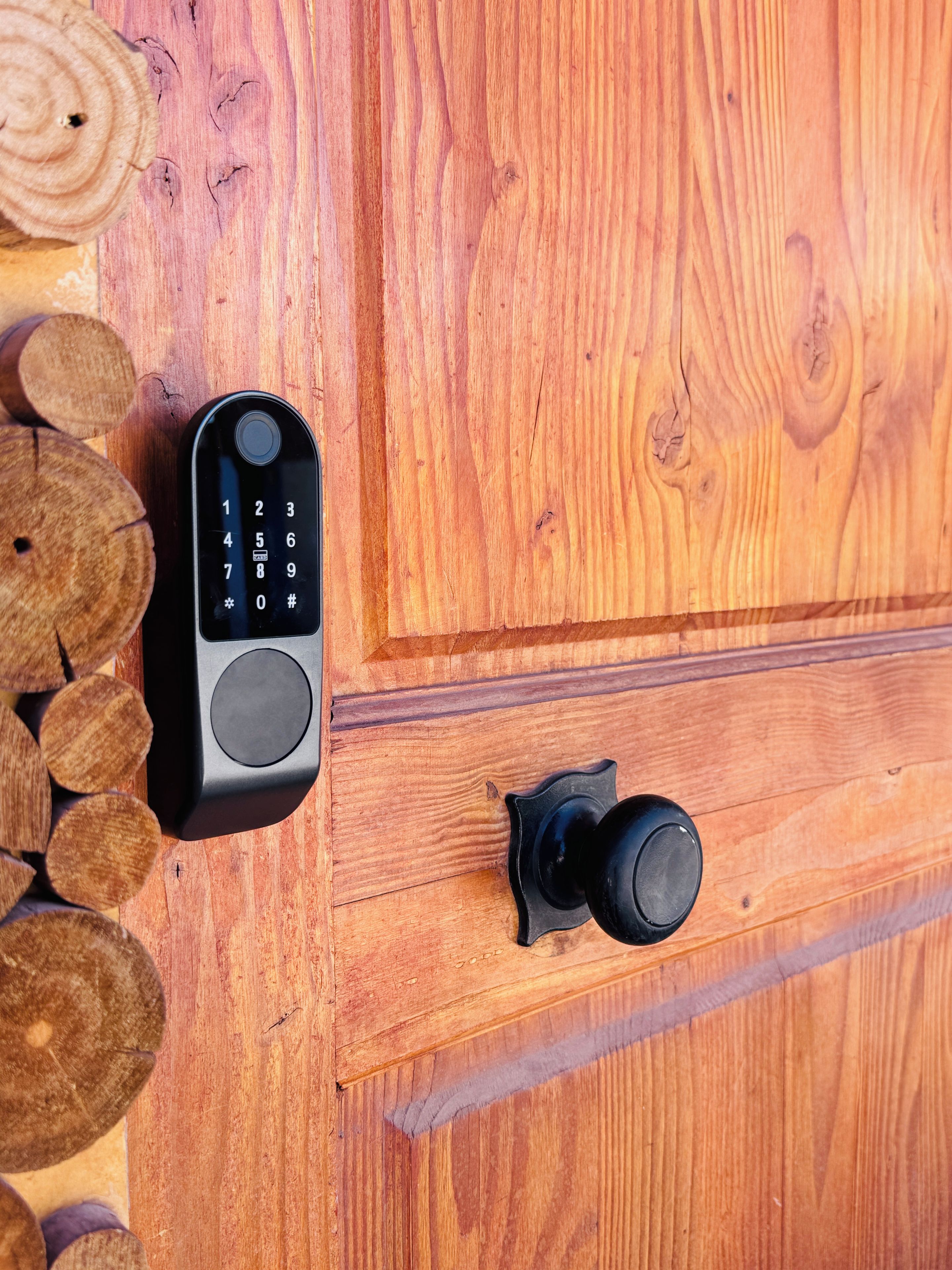 A wooden door with a keypad lock and a door handle.