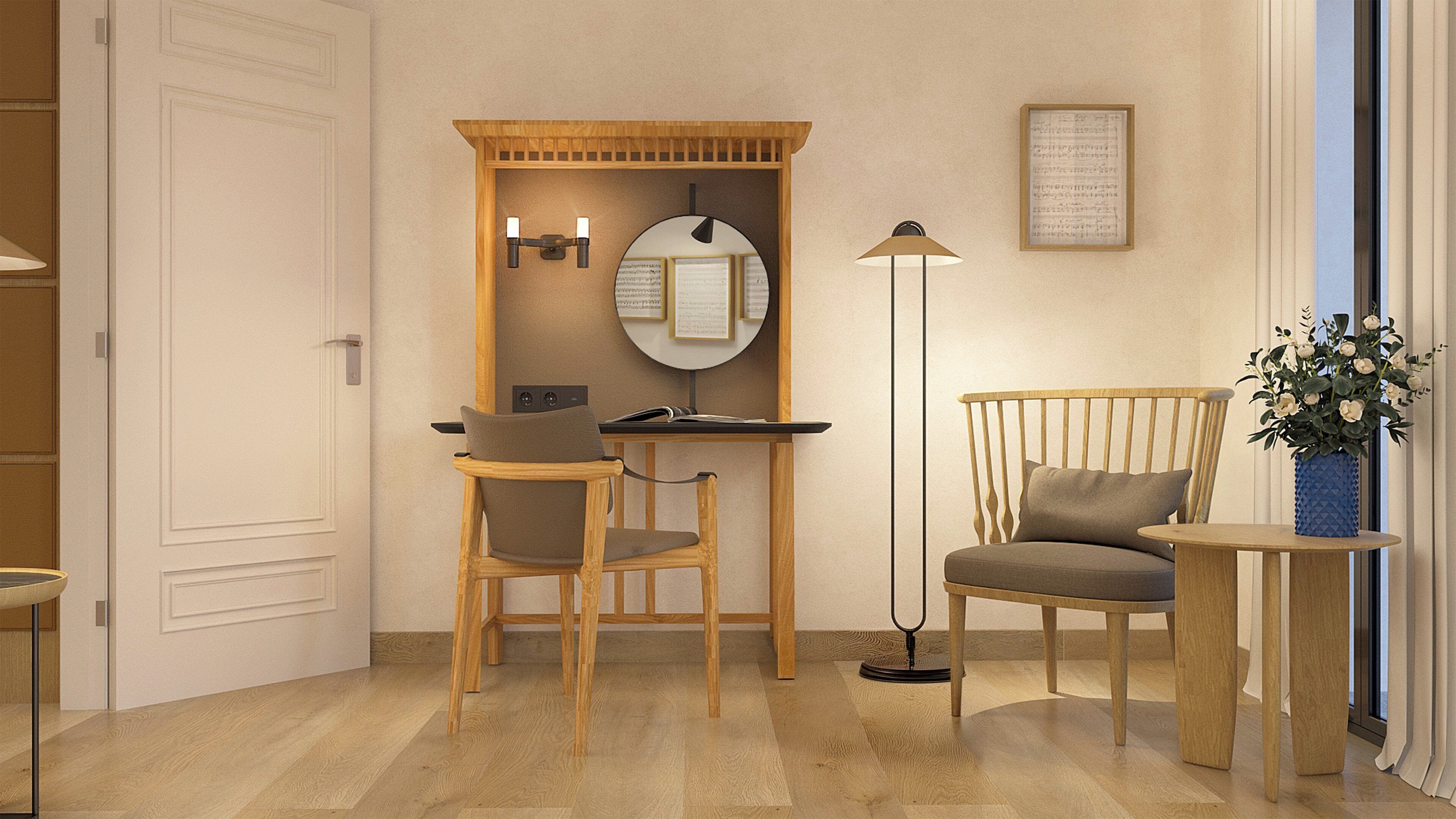A room with a desk, two chairs, a floor lamp, a mirror, and a vase with flowers.