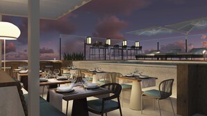 A restaurant with outdoor seating, tables set with plates and glasses, and a view of the sky. - Casa Del Compositor, Vignette Collection by IHG (Jerez de la Frontera)