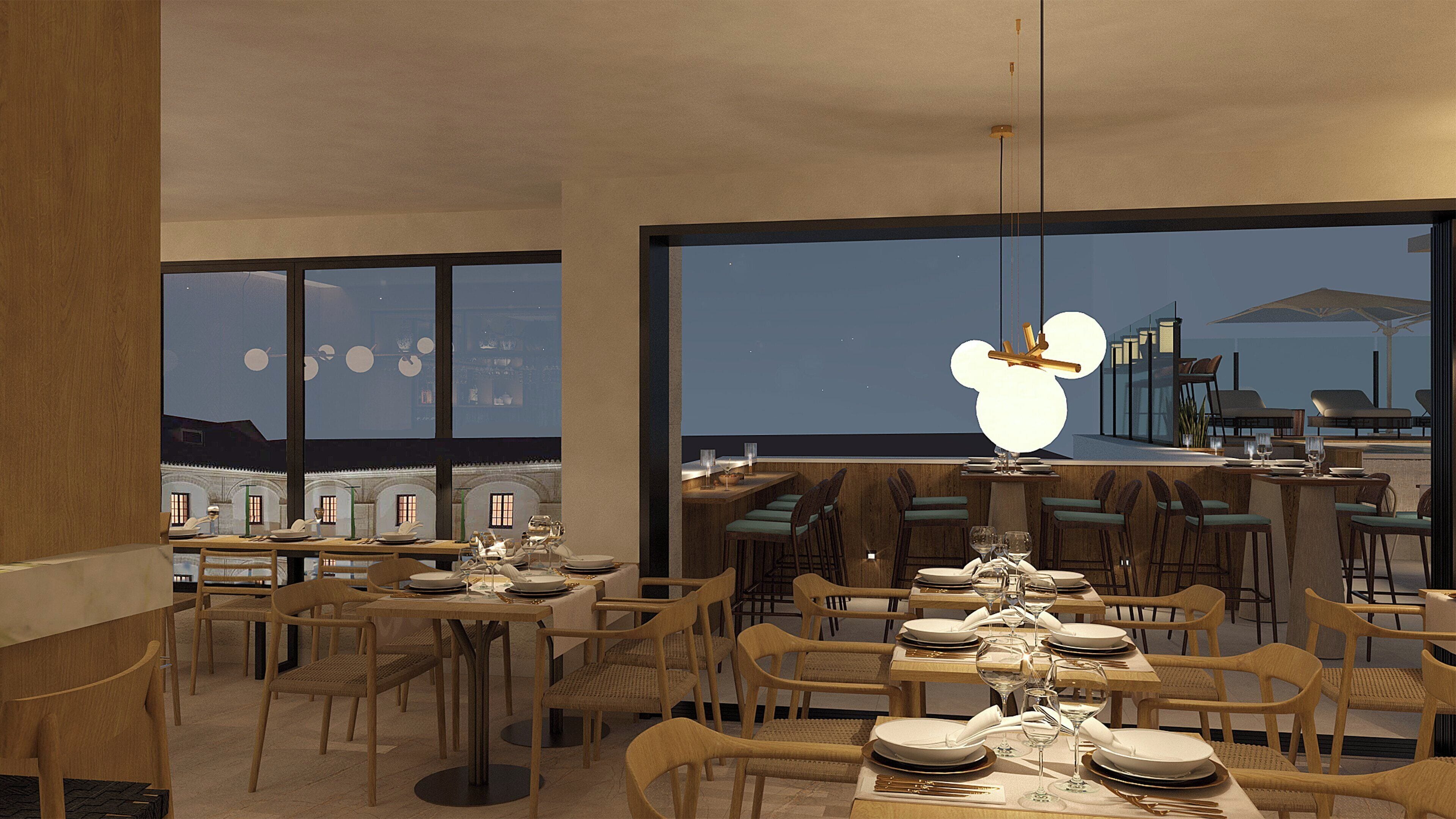 A modern restaurant with multiple dining tables and chairs, large windows offering a view of the cityscape at night.