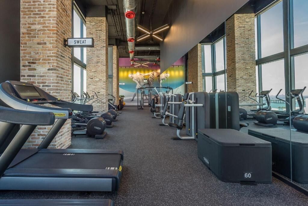 A gym with treadmills, ellipticals, and weight machines.